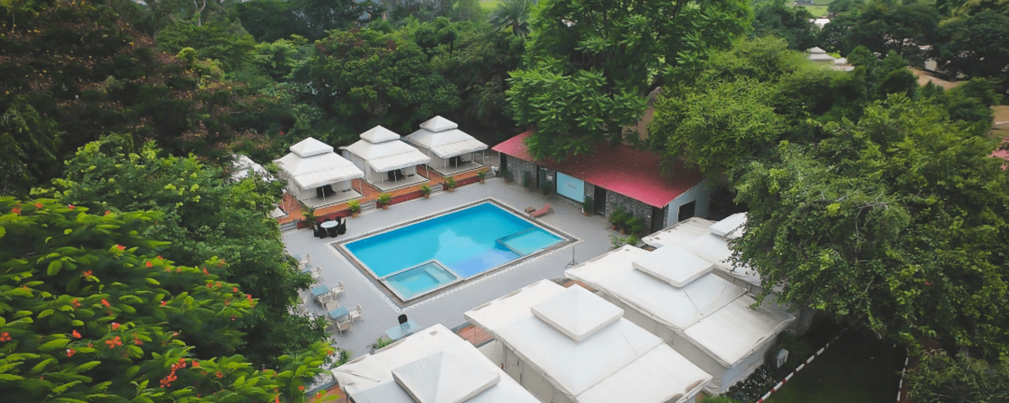 Swimming pool with poolside cabanas at Unwind Resort